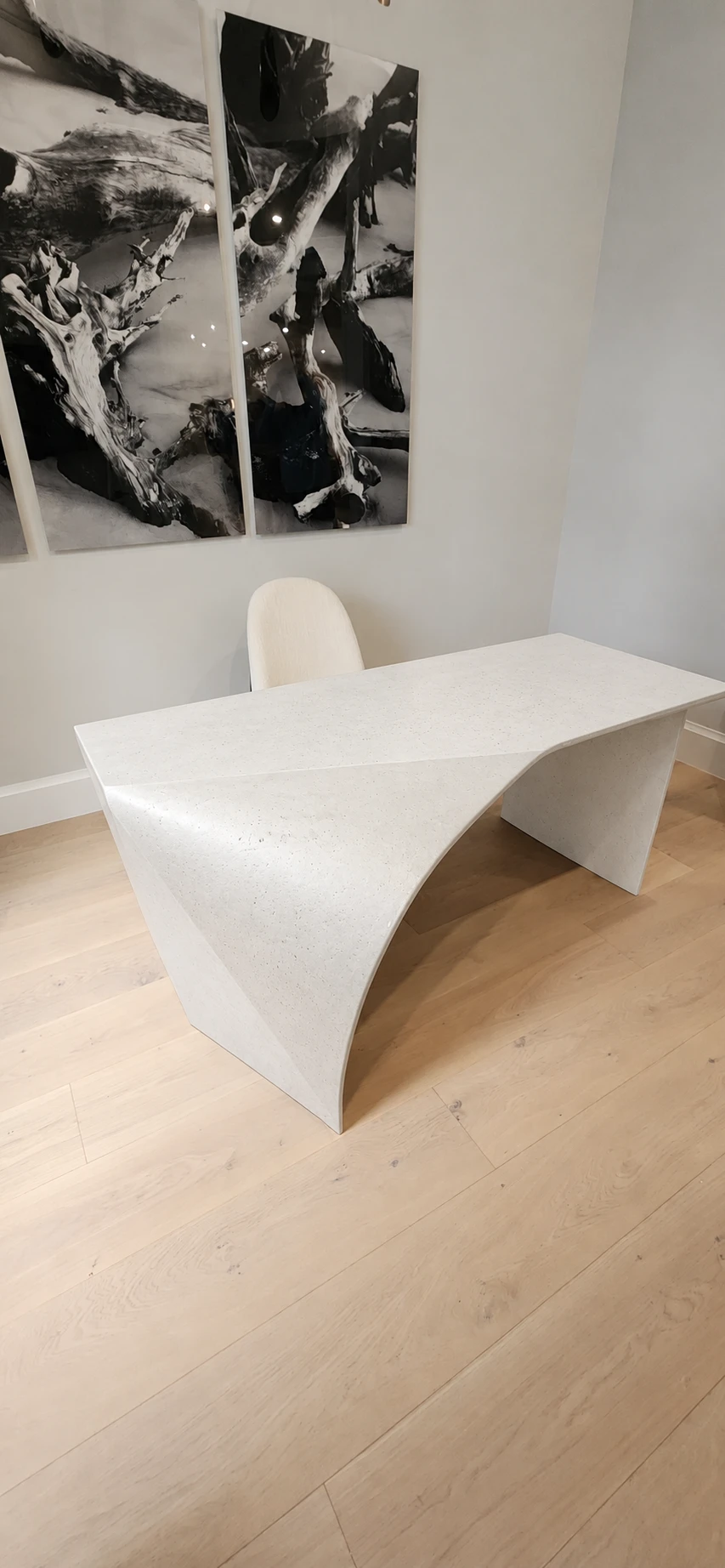 White concrete desk finish preview, showing its sculptural curved sides